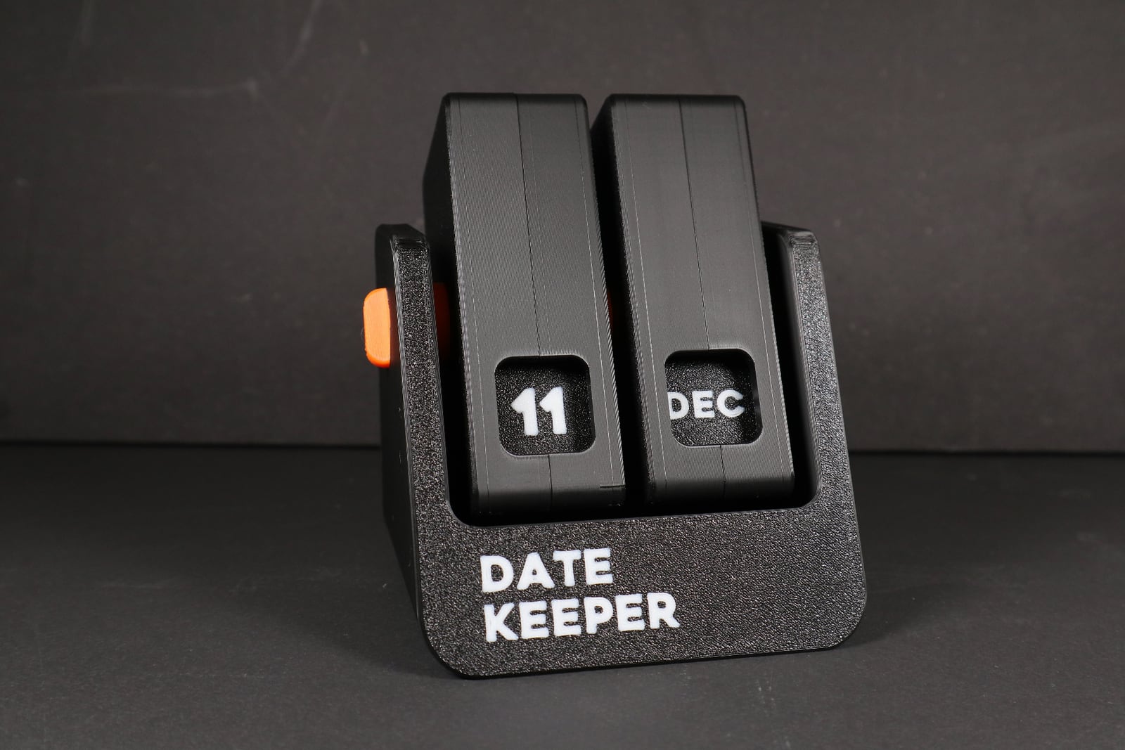 Black 3D-printed desktop date keeper